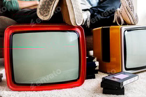 Preview: Two man sitting and two retro television