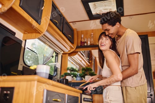 Smiling Couple Cooking Together in a Recreational Vehicle