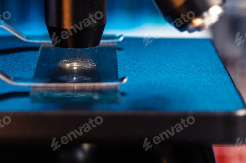Preview: Microscope with lenses close up against dark background