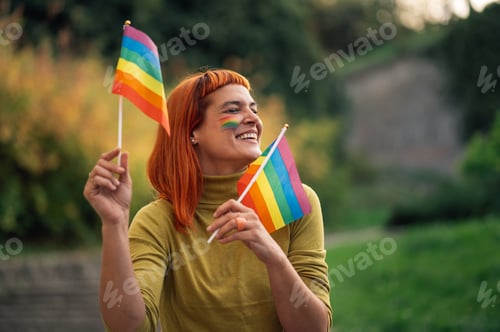 Preview: Happy activist waving rainbow flags at pride parade celebrating lgbtq plus rights