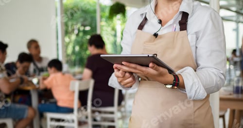 Preview: Service waiter servicing the customer at cash point in cafe.