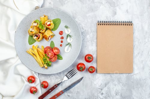 Preview: top view vegetable pate rolls with tomatoes and french fries inside plate on white surface meal