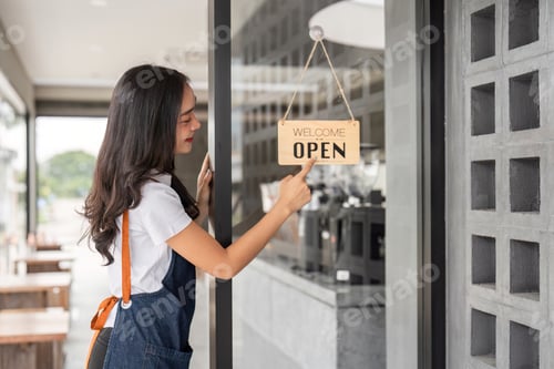 Preview: Young Coffee Shop Staff Opening the Cafe for Business in the Morning