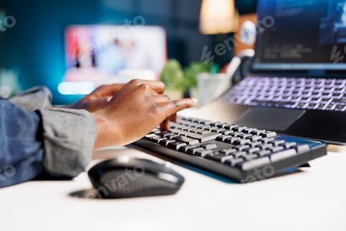 Preview: Person using keyboard to type in code