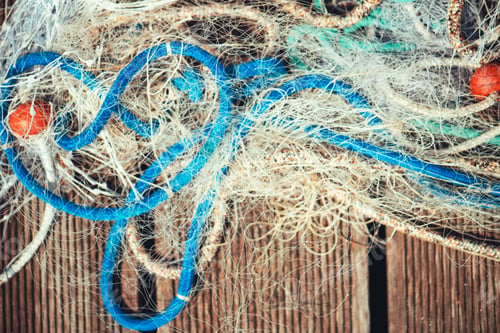 Preview: Pile of commercial fishing net with cords and floats