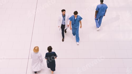 Preview: Overhead View Of Medical Staff Crossing Lobby Of Modern Hospital Building