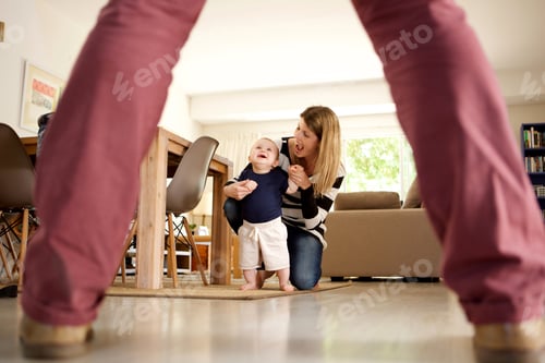 Preview: mother and child smiling together while learning to walk