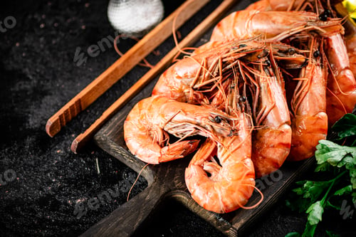 Preview: Boiled shrimp on a cutting board with parsley and spices.
