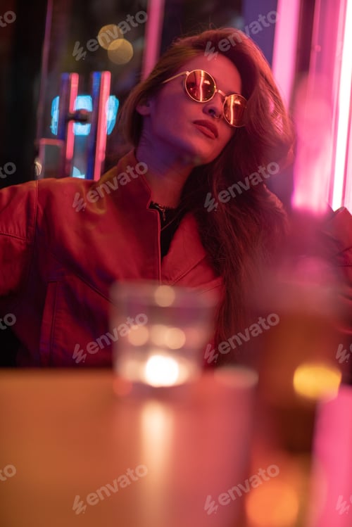 Preview: Portrait of young woman with long black hair and red leather jacket
