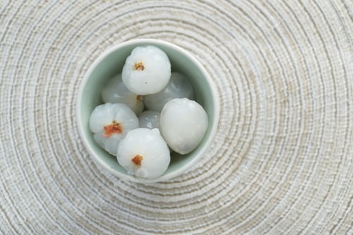 Preview: fresh Lychee in a small bowl on table