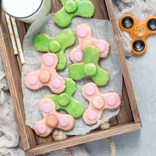 Preview: Homemade shortbread cookies made in trendy spinner toy form, top view, square format