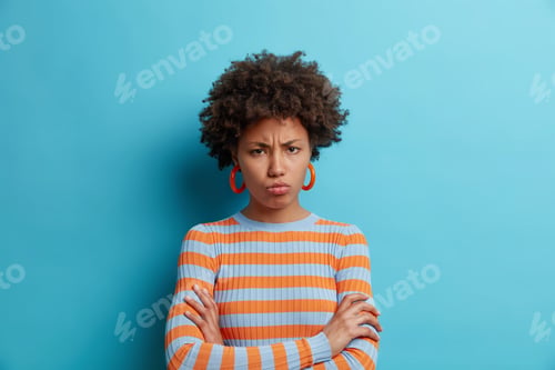 Preview: Sulking displeased young African American being angry and insulted about unfair situation purses lip