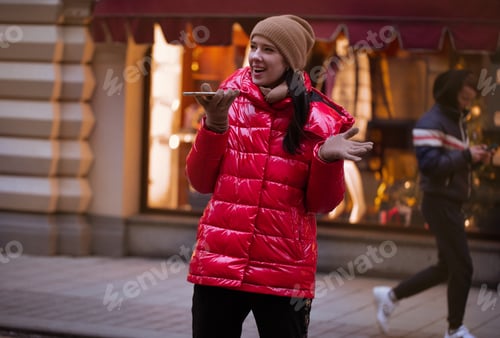 Preview: Young female talking on the phone during winter rime