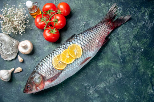 Preview: top view fresh raw fish with lemon slices and red tomatoes on dark-blue background shark seafood