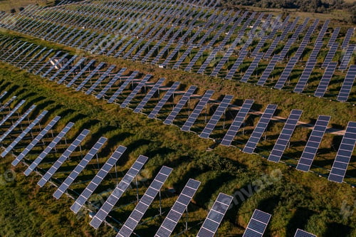 Preview: Aerial view flying over a solar panel farm