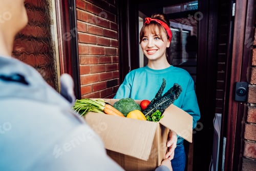 Preview: Home fresh food delivery. Woman taking cardboard box with vegetables and fruits.