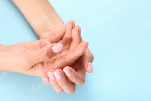 Preview: Closeup view of woman with beautiful hands on color background, space for text. Spa treatment