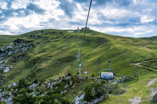 Preview: Chairlift or cable car riding over Stoos village and mountain landscape at Schwyz, Switzerland