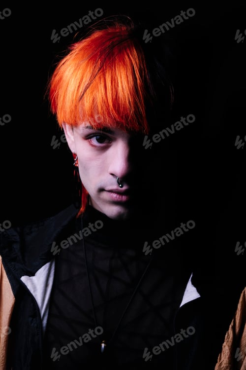Preview: Close-up of boy with black and orange hair looking at camera.