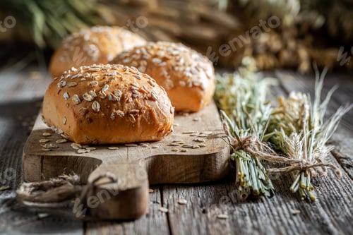 Preview: Fresh and tasty oat buns with ears of grains.