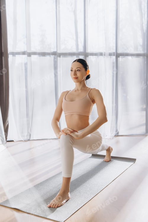 Preview: Young woman practicing yoga crescent lunge pose at home
