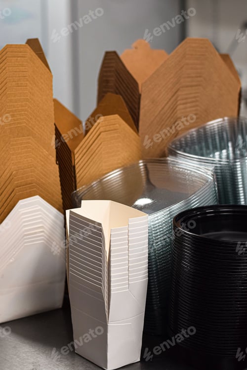 Preview: Stacks of paper and plastic disposable take out containers on a restaurant shelf