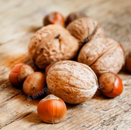 Preview: Hazelnuts and walnuts on an old wooden table
