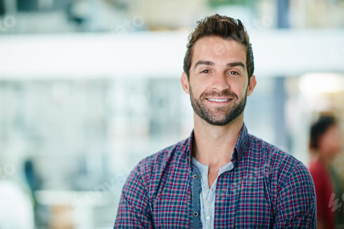 Preview: Smiling his way to success. Portrait of a happy young businessman standing in his office.