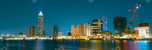 Preview: Rotterdam Business District at Night: Glowing Skyscrapers and City Lights Illuminating the Sky
