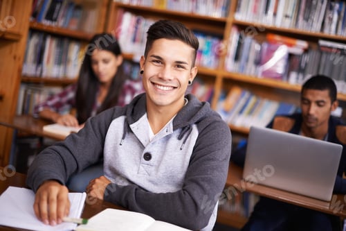 Preview: Cropped portrait of a handsome young student working diligently in his classroom