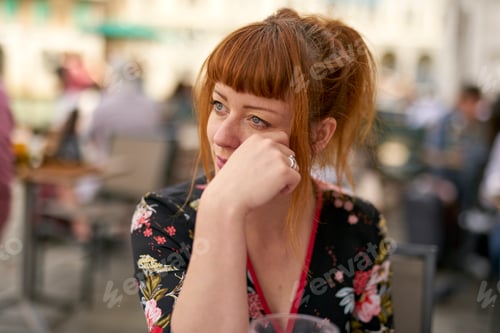 Preview: Caucasian redhead woman with floral dress looking pensive