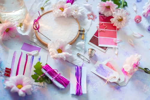 Preview: Blank embroidery frame in pastel tones with flowers and DIY tools. Feminine workplace concept