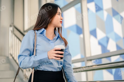Preview: Woman office worker is going to work in the morning with a file and coffee with happiness