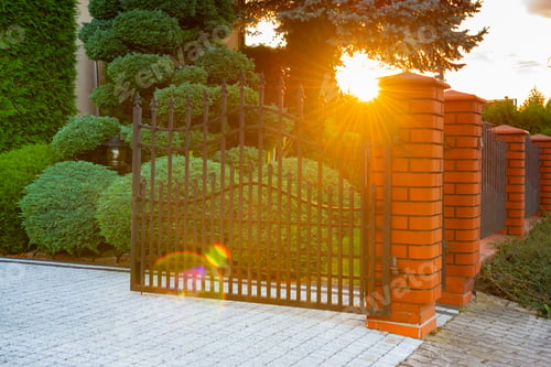 Preview: Open gates of brick fence with iron railing outdoors