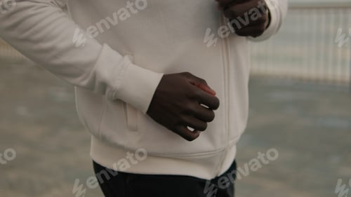 Preview: Close-up of athlete running along the seaside promenade, cardio workout