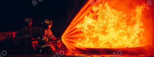 Preview: Fearless Firefighters Battling Blaze with Water and Extinguishers.