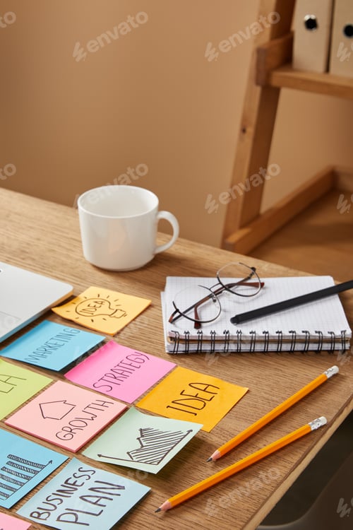Preview: paper stickers with business strategy and cup of coffee on tabletop