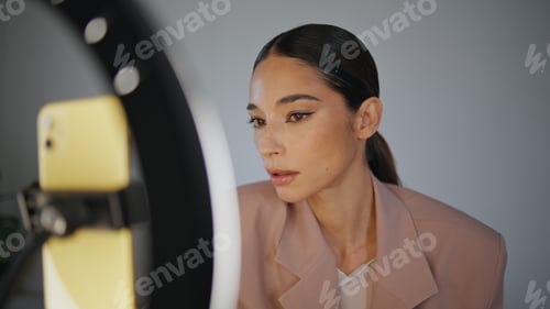 Preview: Blogger woman setting smartphone at home close up. Influencer girl greeting blog