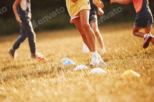 Preview: Through obstacles. Kids running in the field at sunny day. Conception of healthy lifestyle