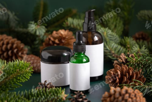 Preview: Brown glass jars near fir branches and pine cones on dark green close up. Brand packaging mockup