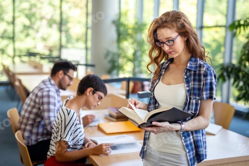 Preview: Students studying in library. Young success people are spending time together and learning together