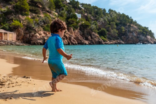 Preview: A little boy enjoying the summer on the beaches of Ibiza on holiday at San Vicente beach