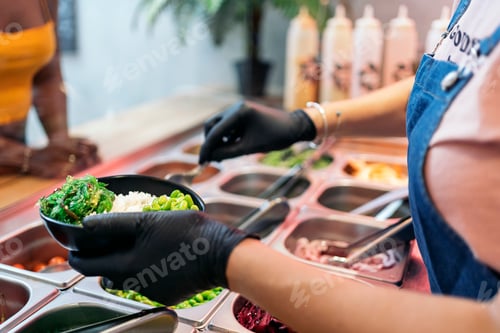 Preview: Woman Adding Ingredients Into Poke Bowl