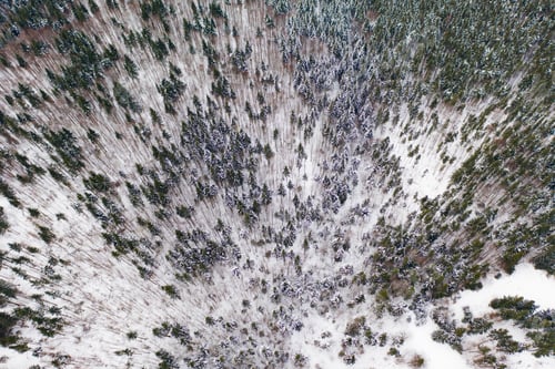 Preview: Aerial drone view of a winter landscape. Snow covered forest.