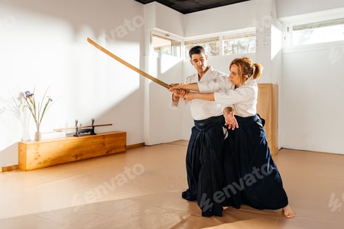 Preview: Man and Woman Practicing Martial Arts With Bokken Defense