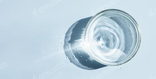 Preview: petri dish with liquid water on plain on a light background water ripple texture