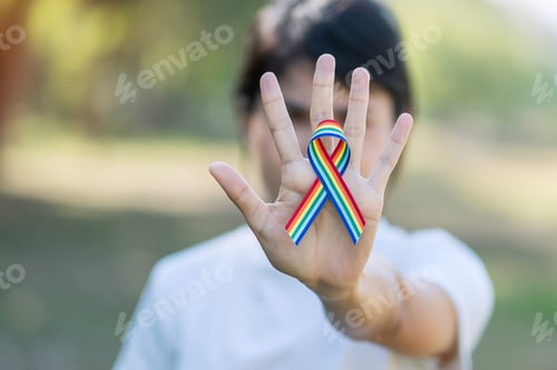 Preview: hand showing LGBTQ Rainbow ribbon