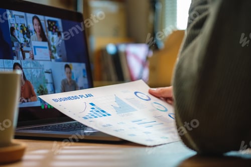 Preview: asisn woman video conference busienss meeting with colleage online with laptop at home