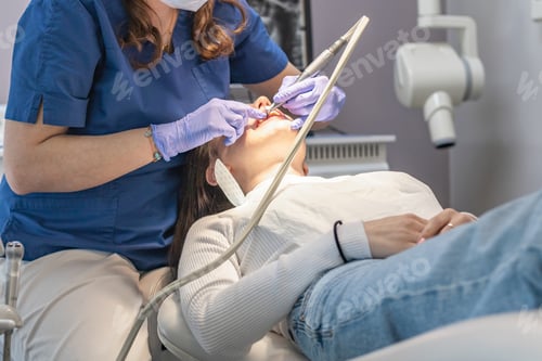 Preview: The dentist cleans the patient's mouth.