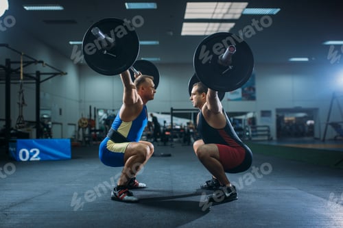 Preview: Two male weightlifters doing squats with barbells